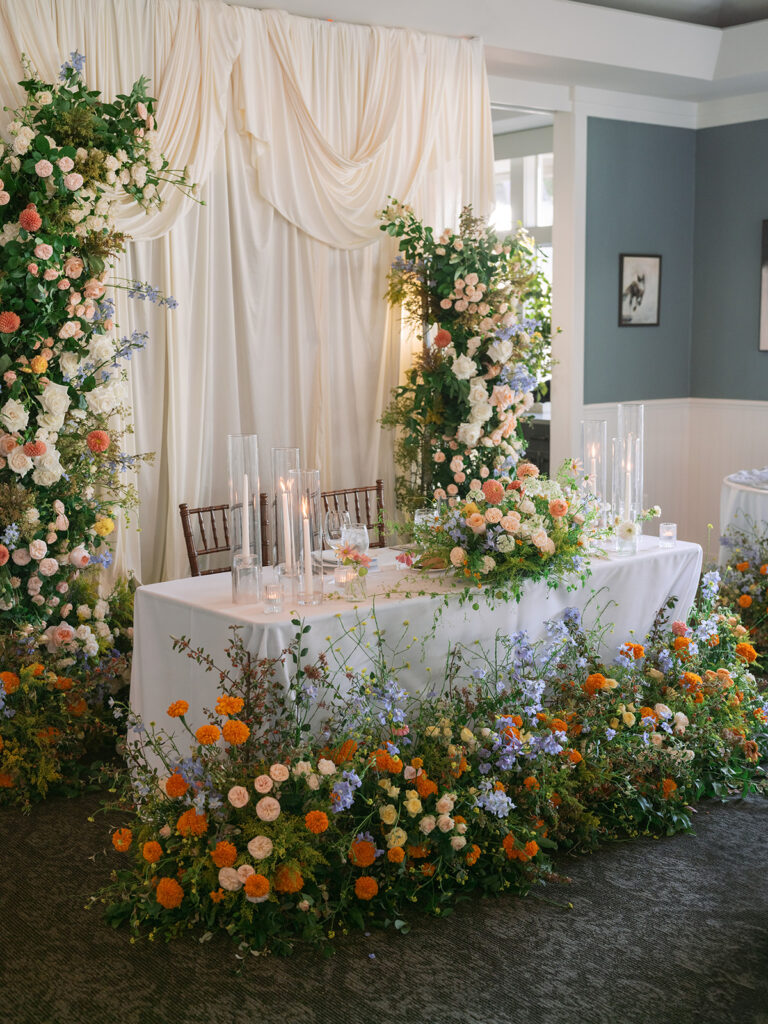 Half Moon Bay Golf Links sweet heart table decor with stunning florals and draping