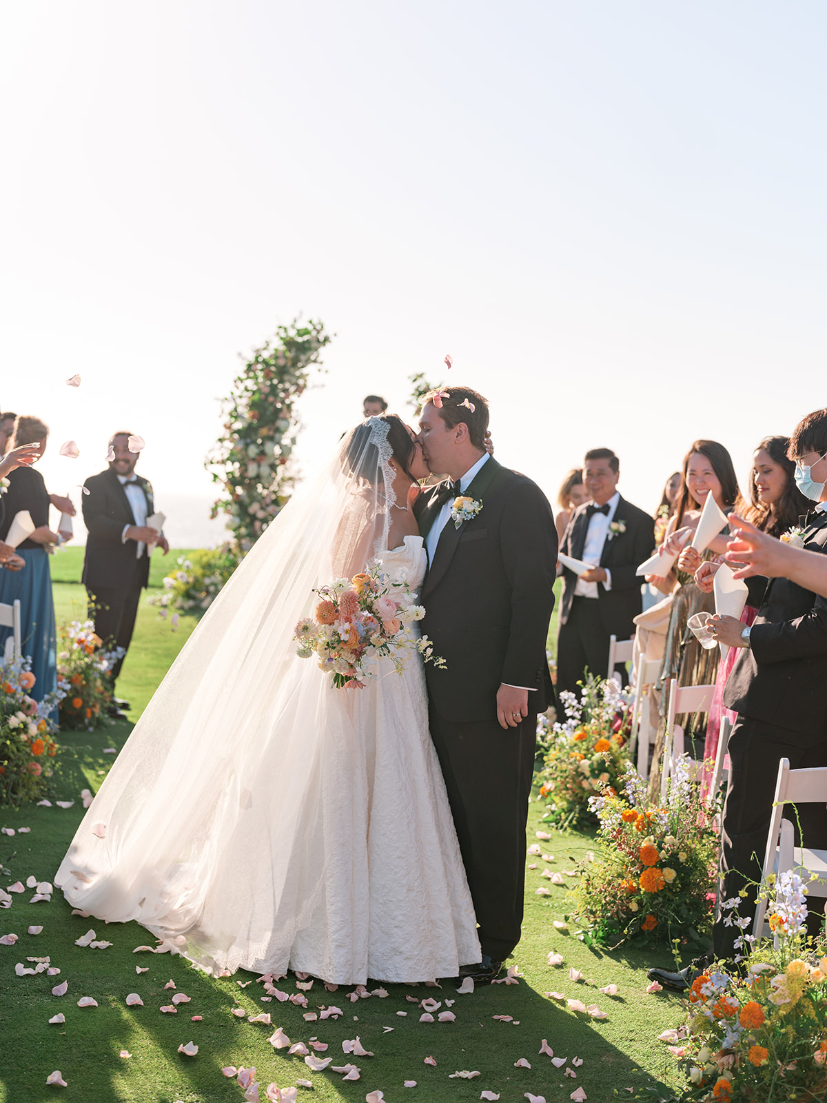 Bride and groom share a kiss during their Half Moon Bay wedding