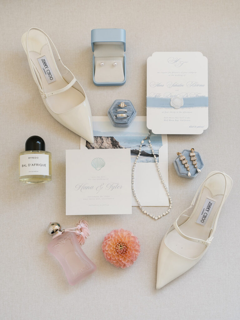 Pastel pink and coastal blue flat lay with Jimmy Choos and His and hers perfume
