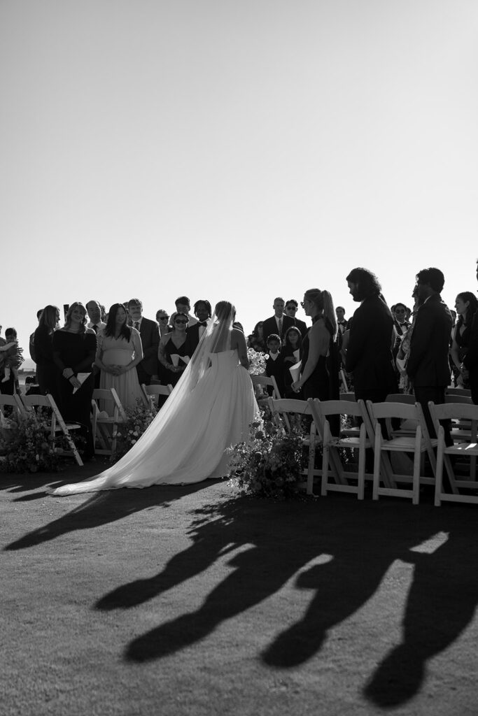 Black and white image of the bride's entrance during wedding ceremony