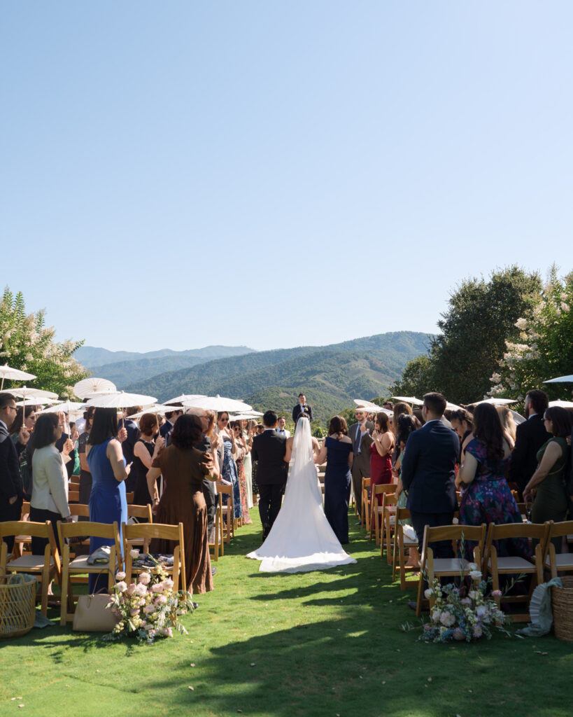 Bride's entrance with stunning mountain views at her Holman Ranch wedding