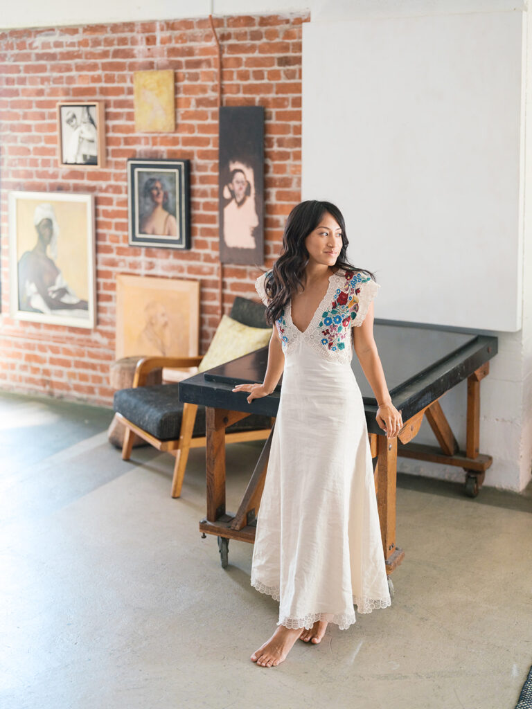 A solo portrait of a bride-to-be in her loft studio in the san francisco bay area