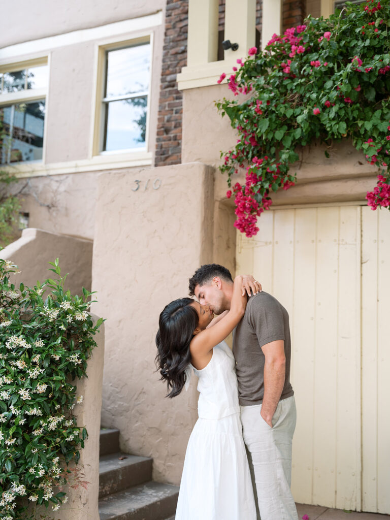Newly engaged couple kiss in downtown Oakland for their bay Area engagement photos