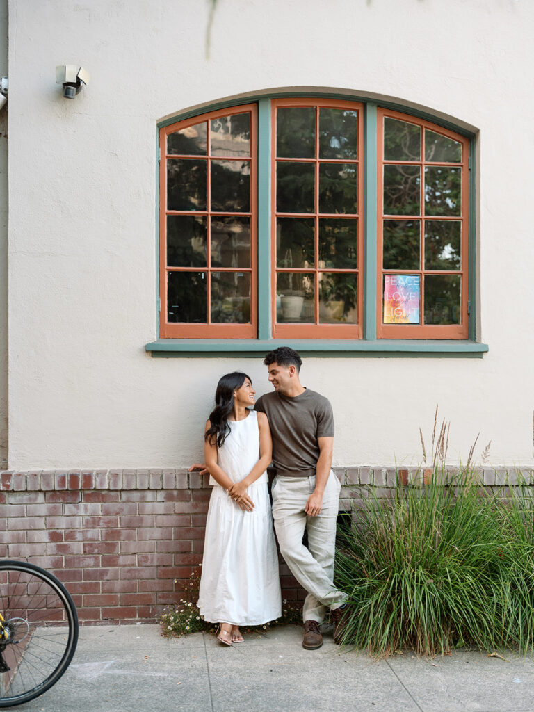Kelli and Frank pose in downtown Rockridge in Oakland for engagement photos