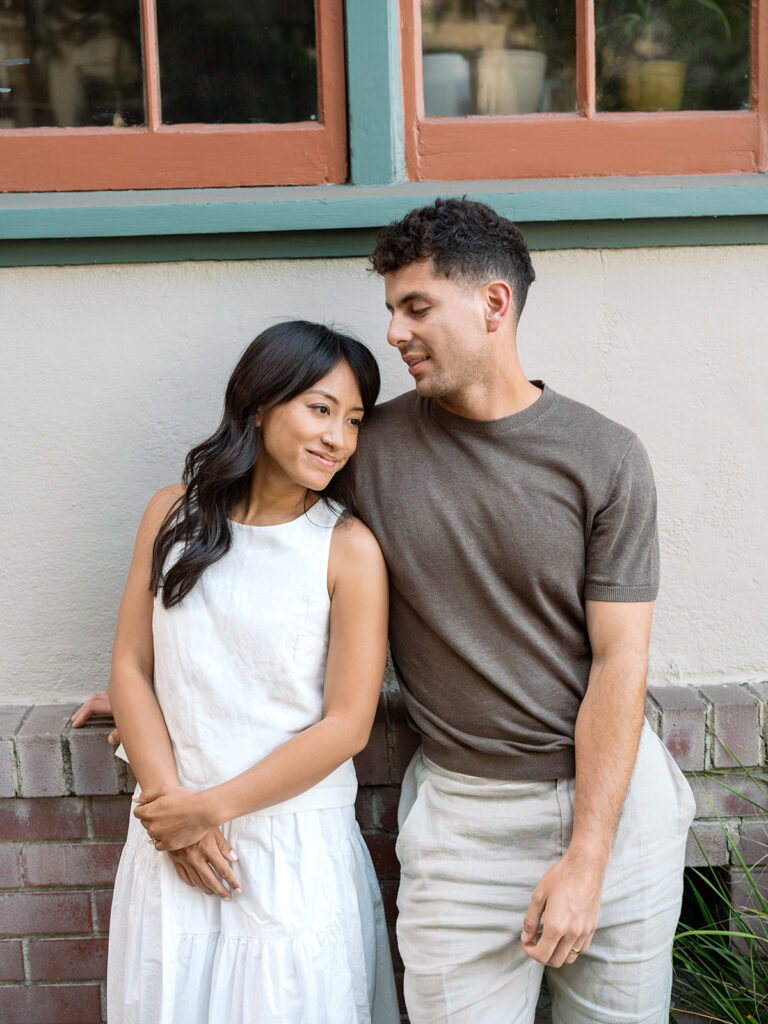 Kelli and Frank pose in downtown Oakland for their engagement photos