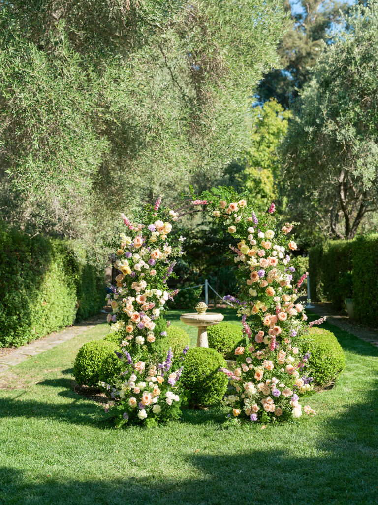 Colorful whimsical wedding arch at Allied Arts Guild, a Bay Area wedding venue for romantics