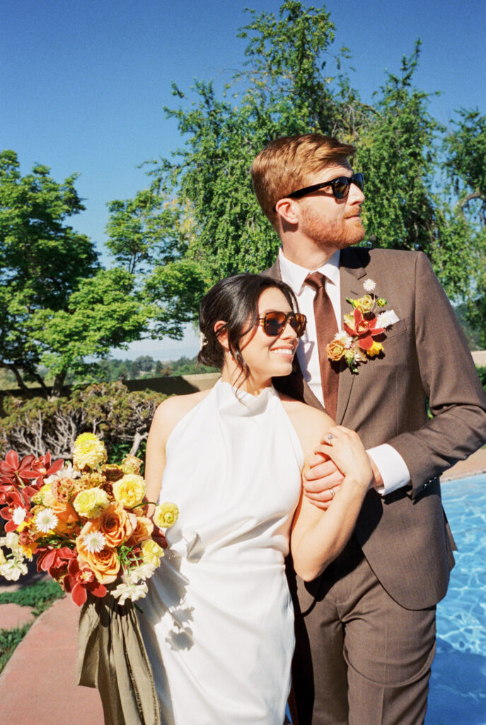 bride and groom celebrate their wedding at the Marin County Civic Center fountain