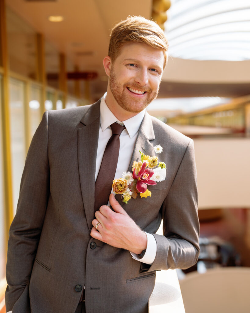 groom with his wedding boutonierre