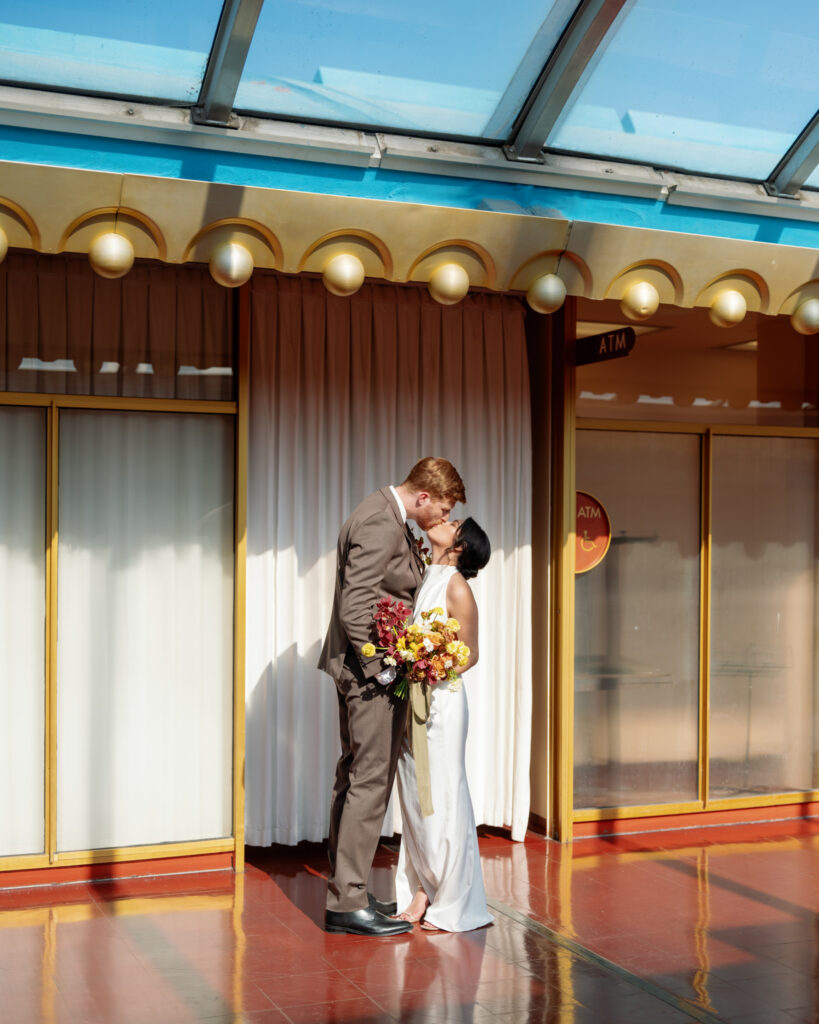 bride and groom kiss during their wedding at the Marin County Civic Center