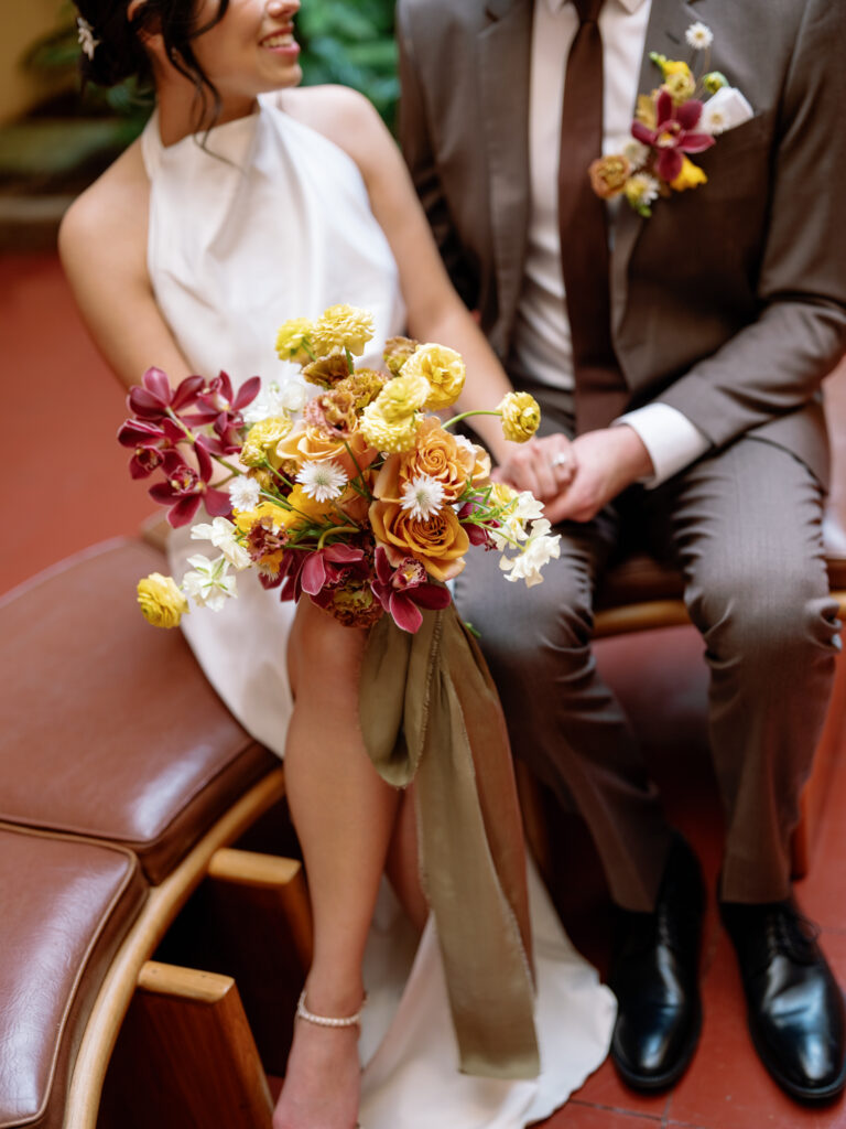bride and groom sitting on the bench after their civil ceremony at the Marin County Civic Center