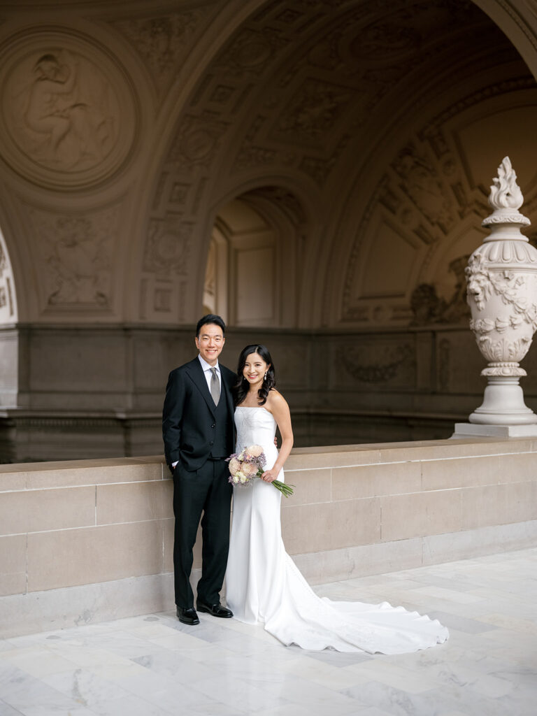 Bride and groom portrait under the Beaux-Arts rotunda colonnade at San Francisco City Hall — San Francisco City Hall wedding photographer